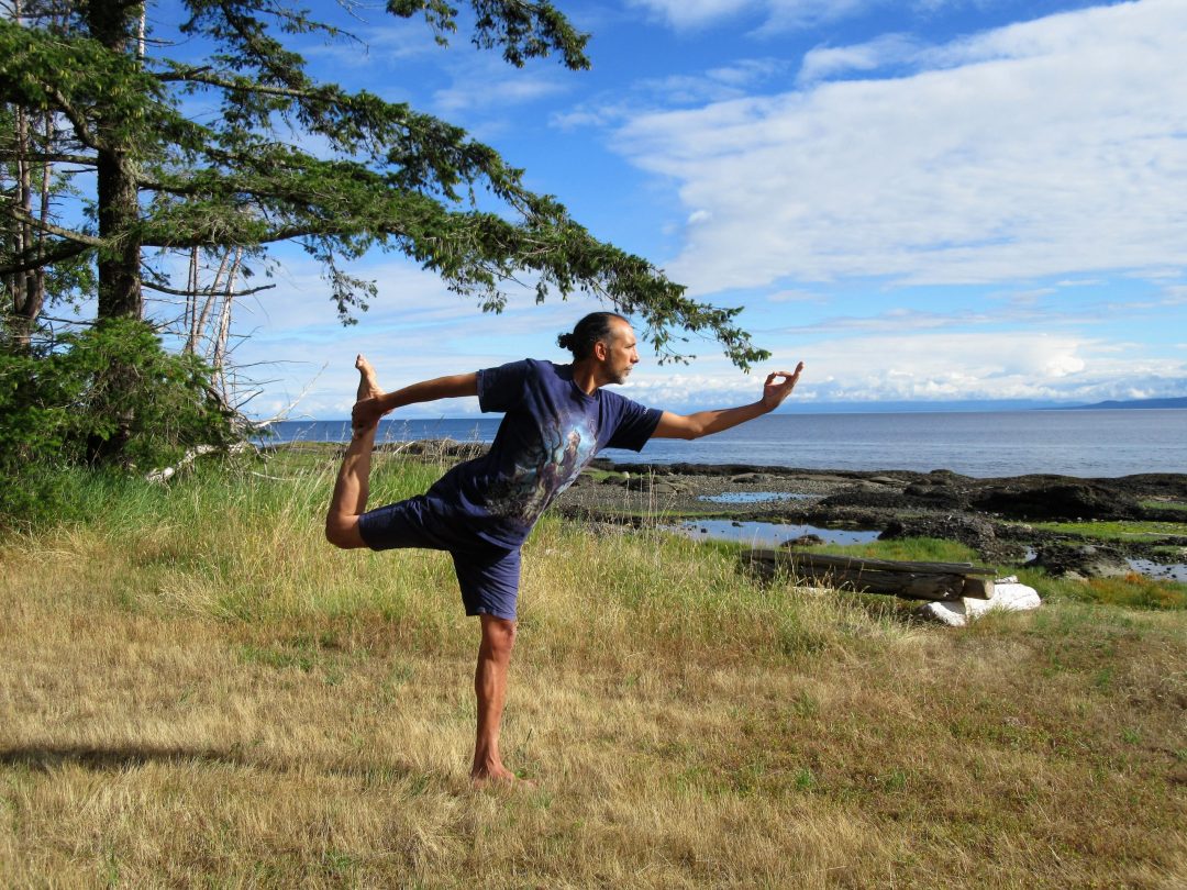 IMG_0527 (2) Man standing on one leg in a Yoga pose, near the sea.